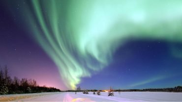 Northern Lights dancing over snowy landscapes in Lapland during winter – Best Activities to do while on Norway & Finland’s northern lights tour during winters